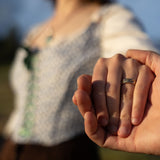 Two people holding hands with a blurred background