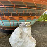 Close-up of a ring on a crystal on a textured surface with a blurred background